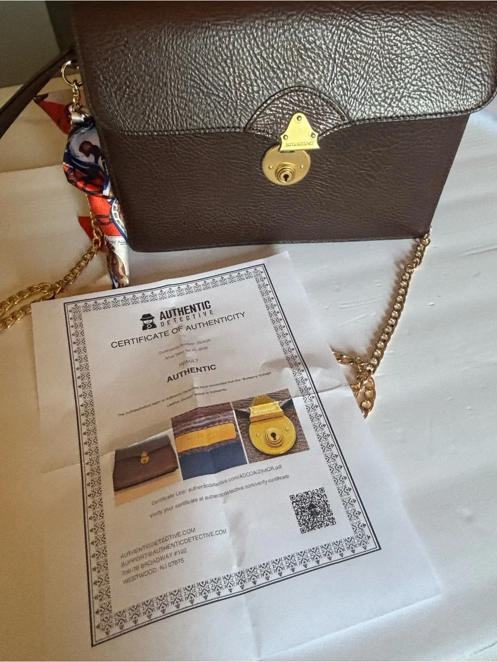 Burberry Brown Leather Clutch with Gold-Tone Lock and Scarf Accent